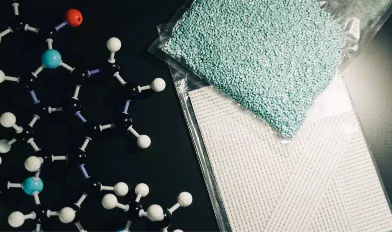 molecule models and pills in pockets on black table belong to lsd legal brand.